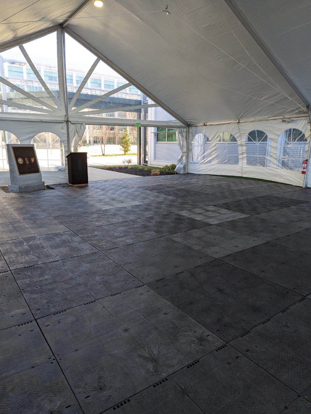 Black dance floor under a clear-top tent