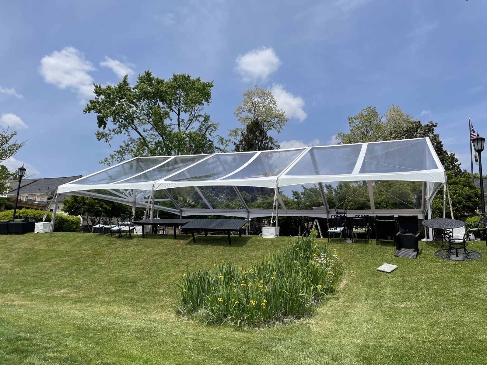 Clear-top tent on a lawn in daylight