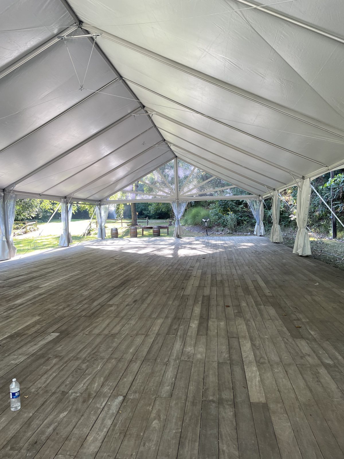 Draped tent interior with wood-look flooring