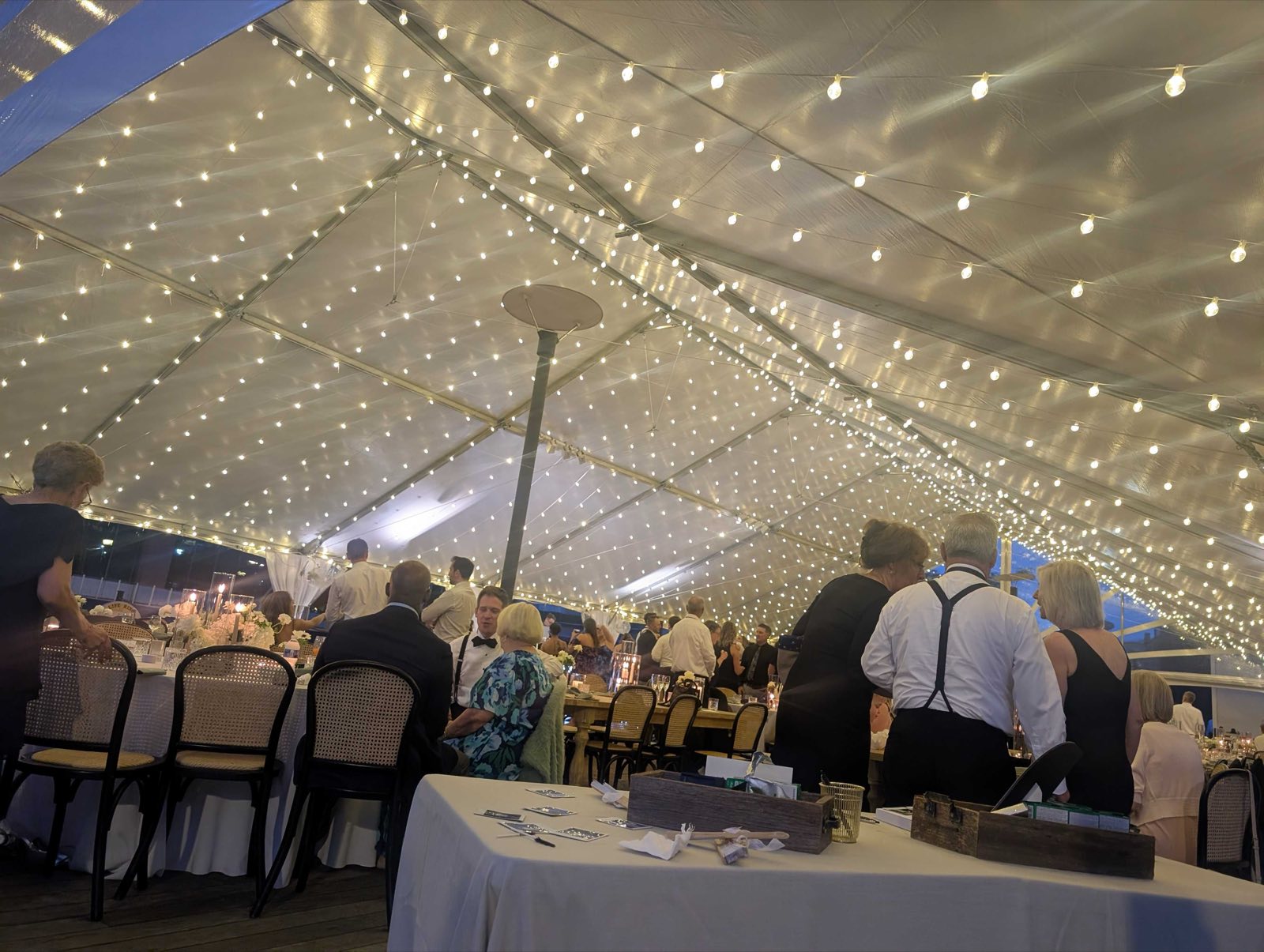Fairy-light canopy over a wedding dinner