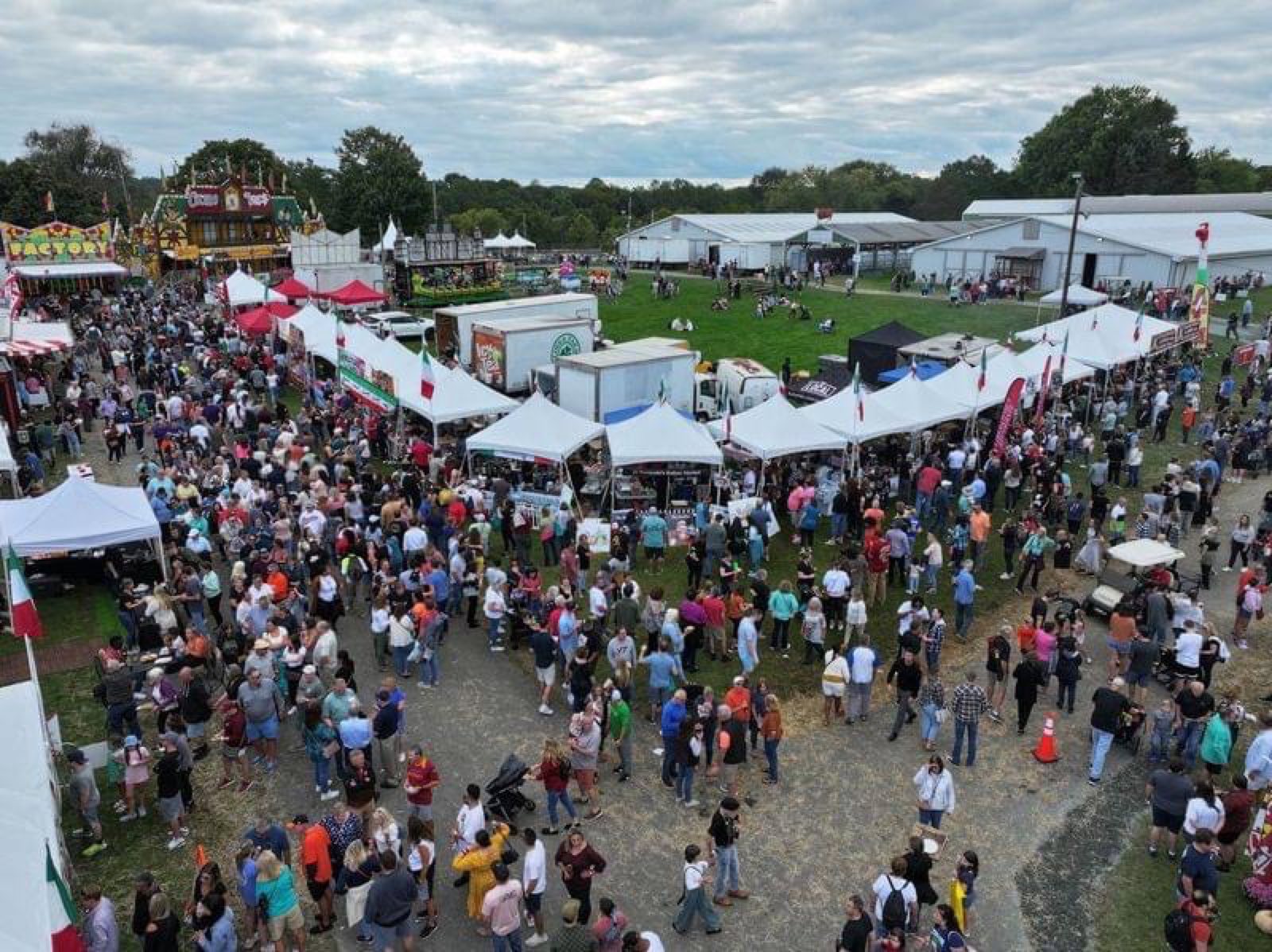 Festival crowd among event tents, seen from above