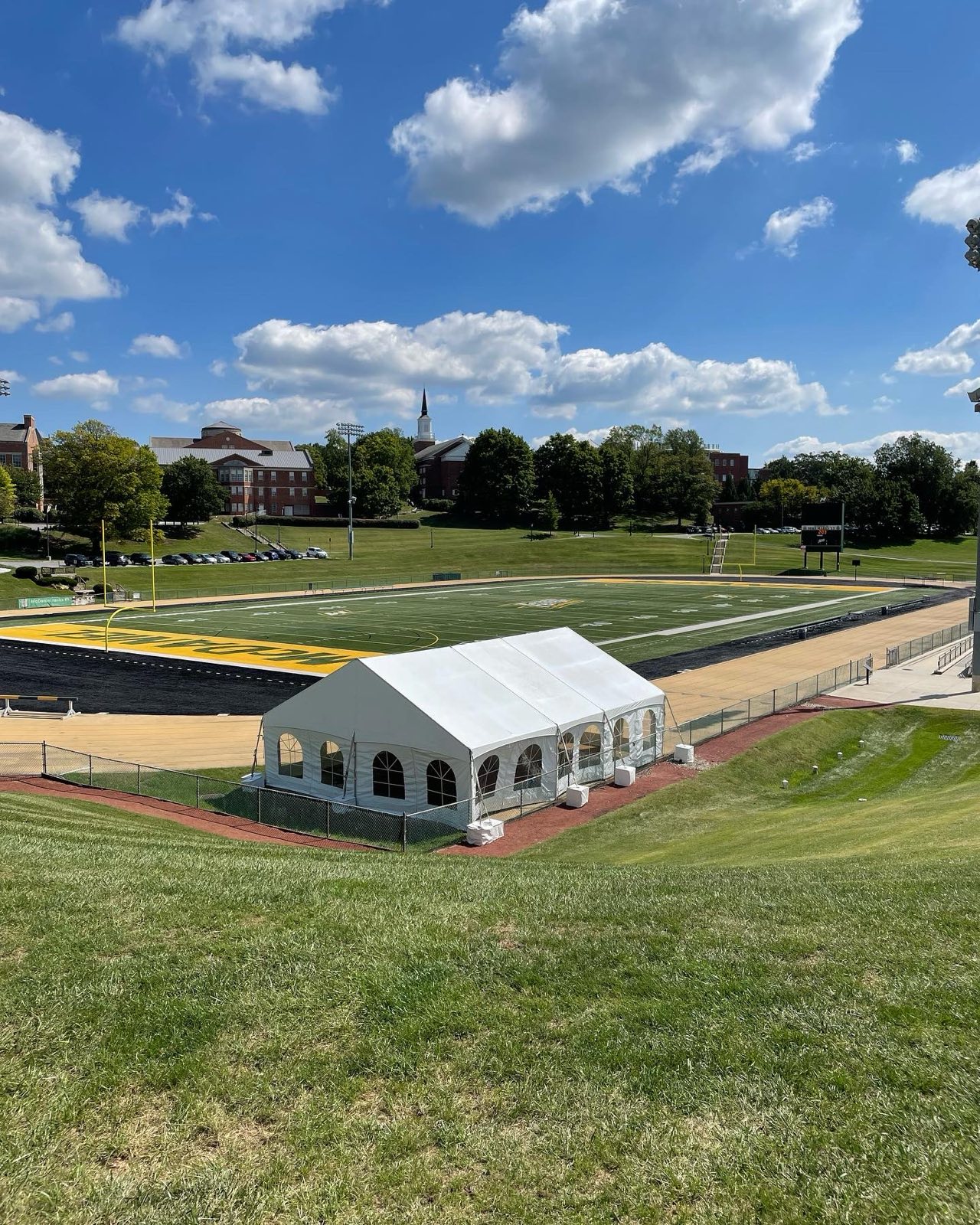 Frame tent set up beside an athletic field