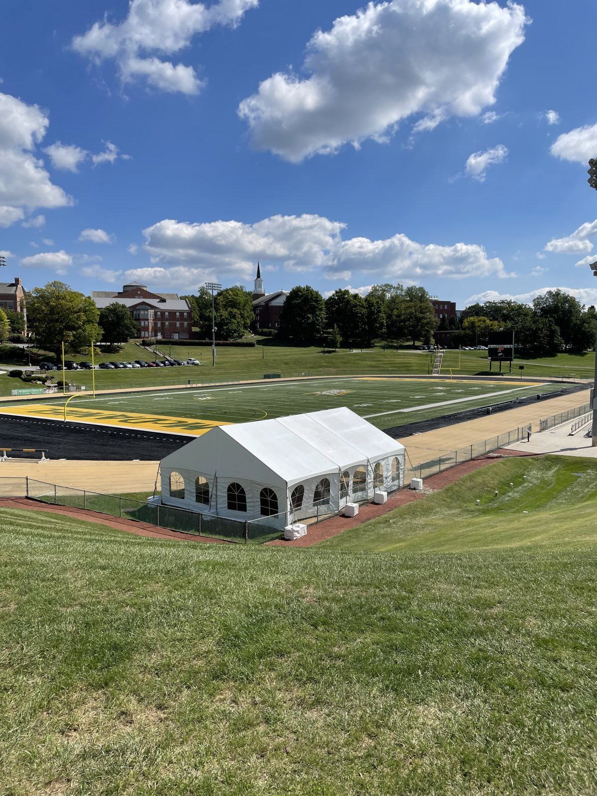 Frame tent beside a running track for a campus event