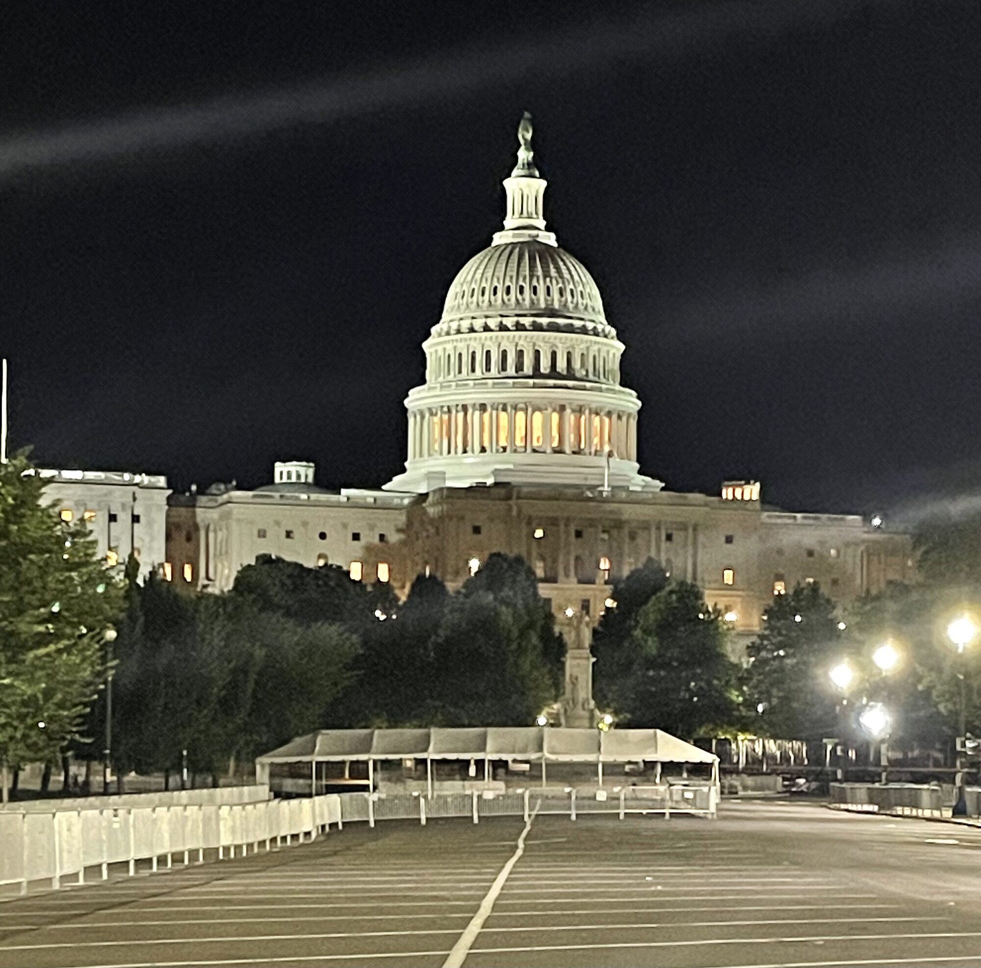 Frame tents at the US Capitol at night