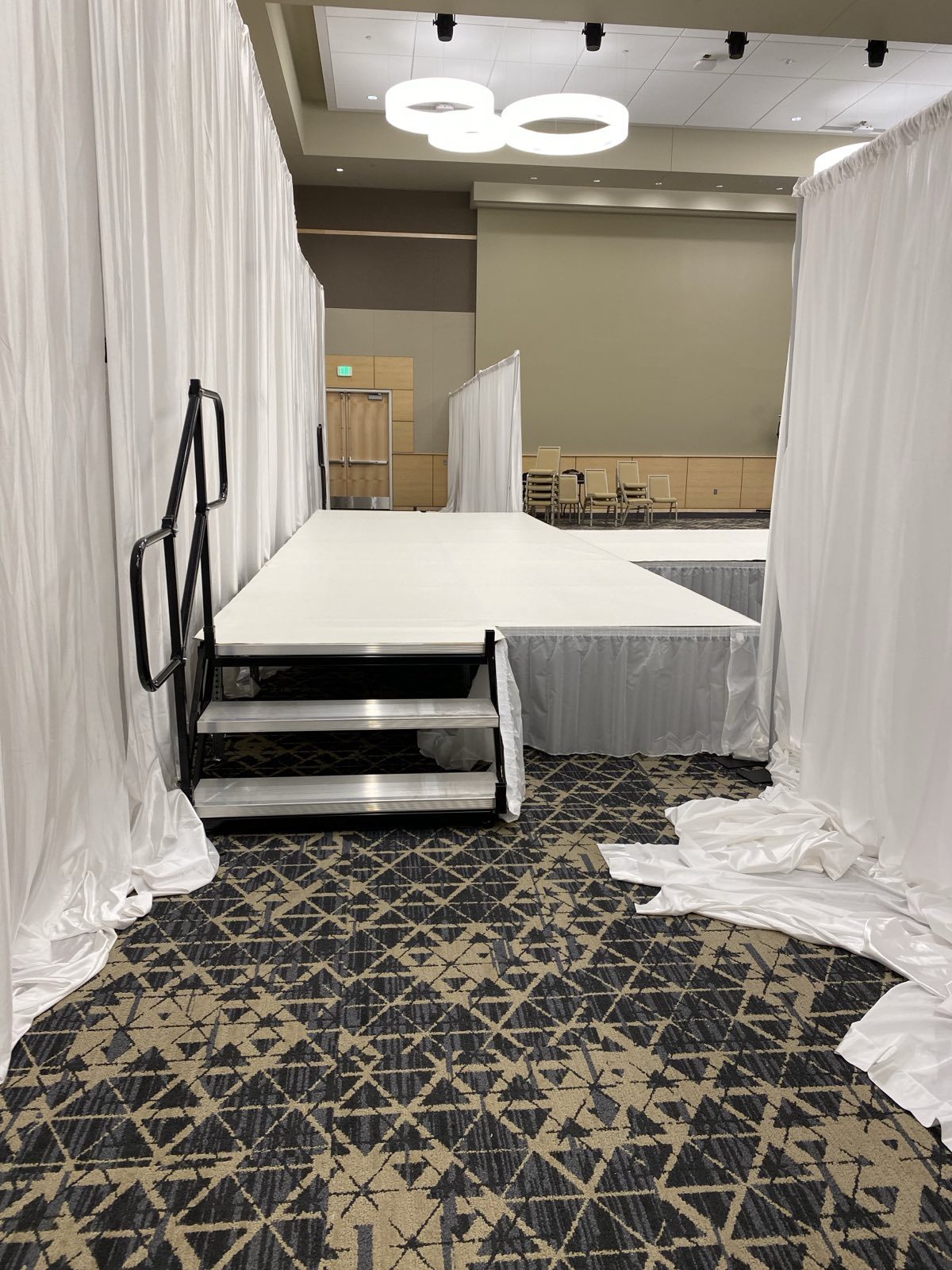 Indoor stage with steps and white drape