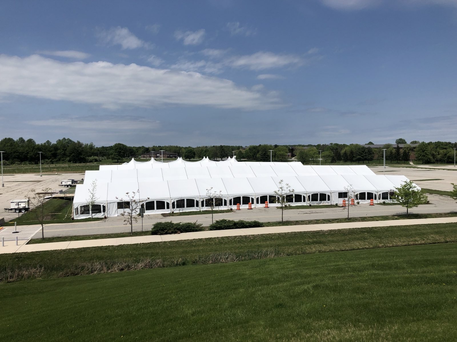Aerial view of a large pole tent on open grounds