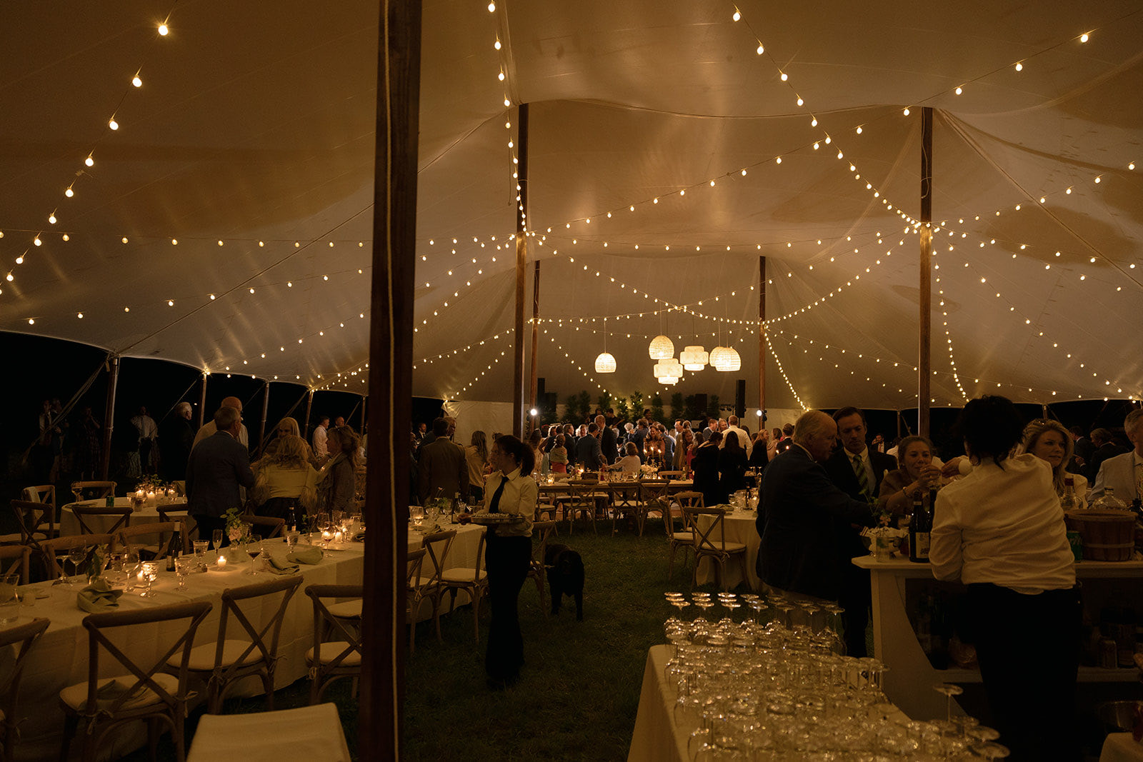 Night wedding reception under tent string lights