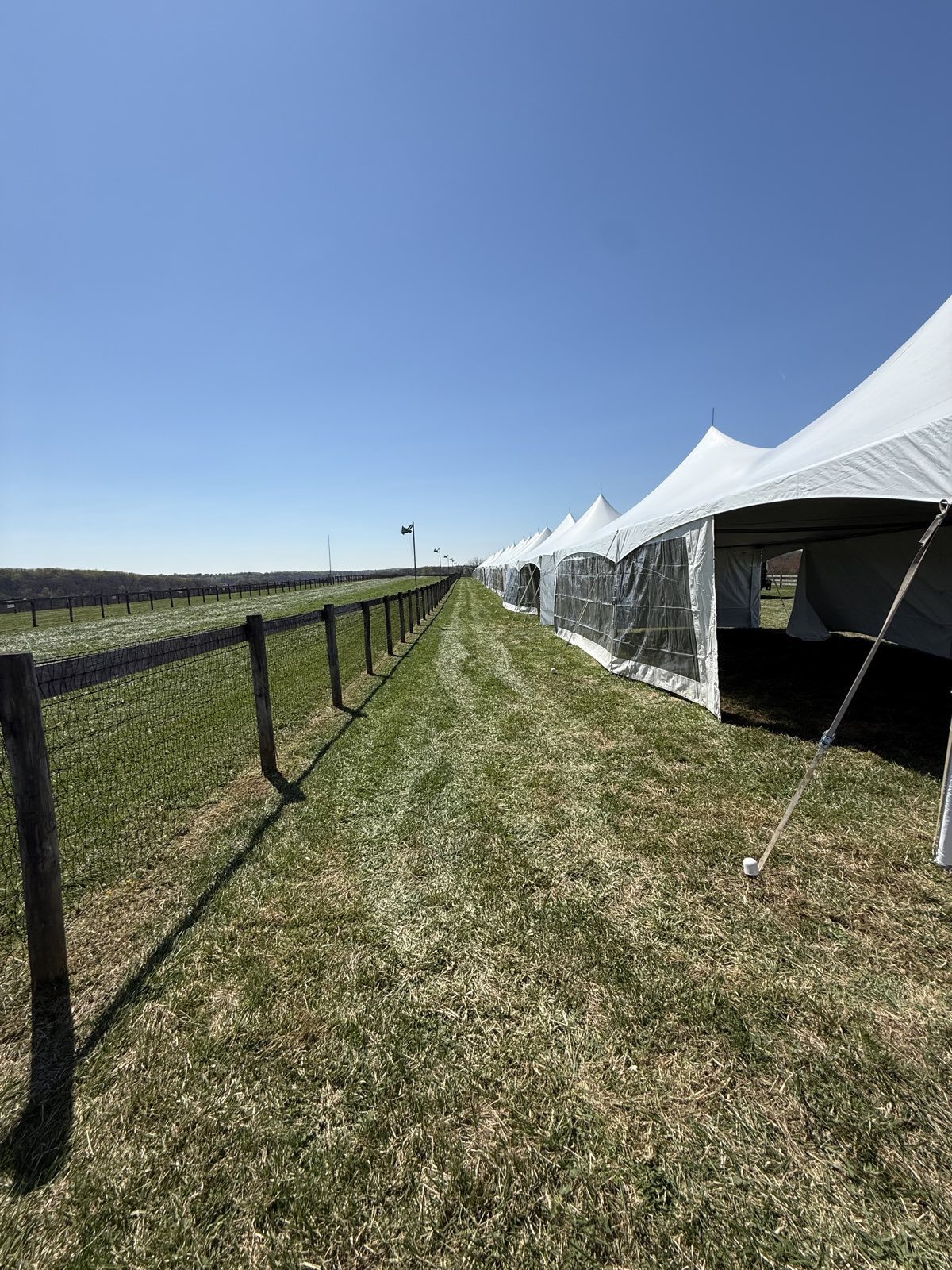 Frame tents along the rail at a race course