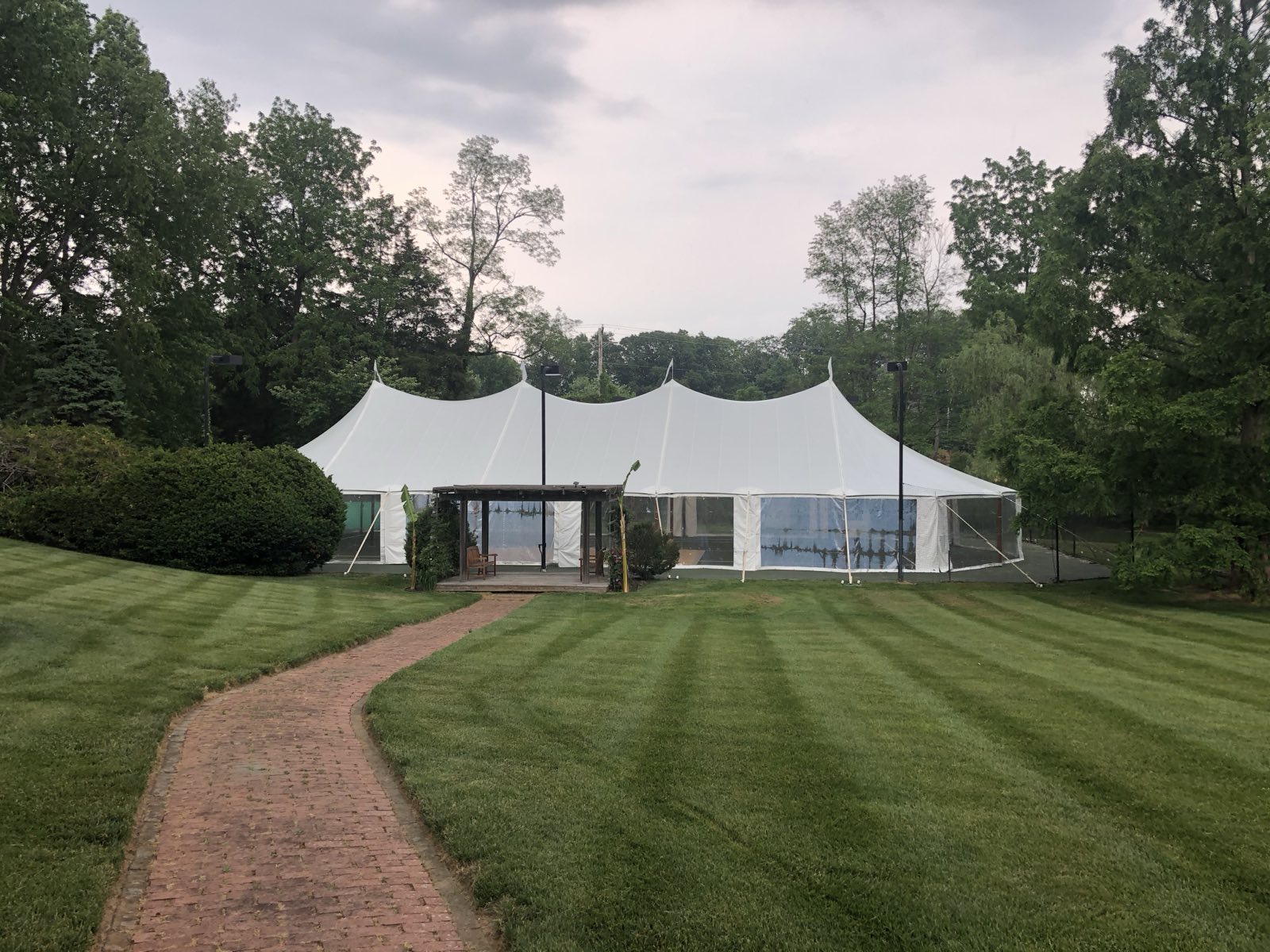 Sailcloth tent with a brick path leading to the entrance