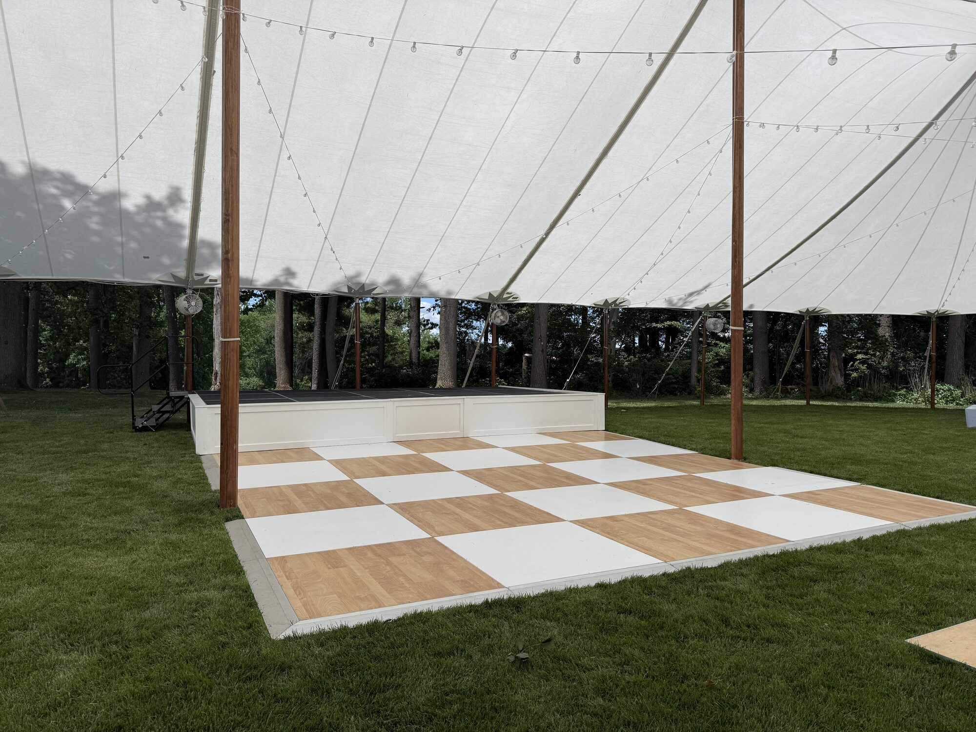 Dance floor and string lights under sailcloth