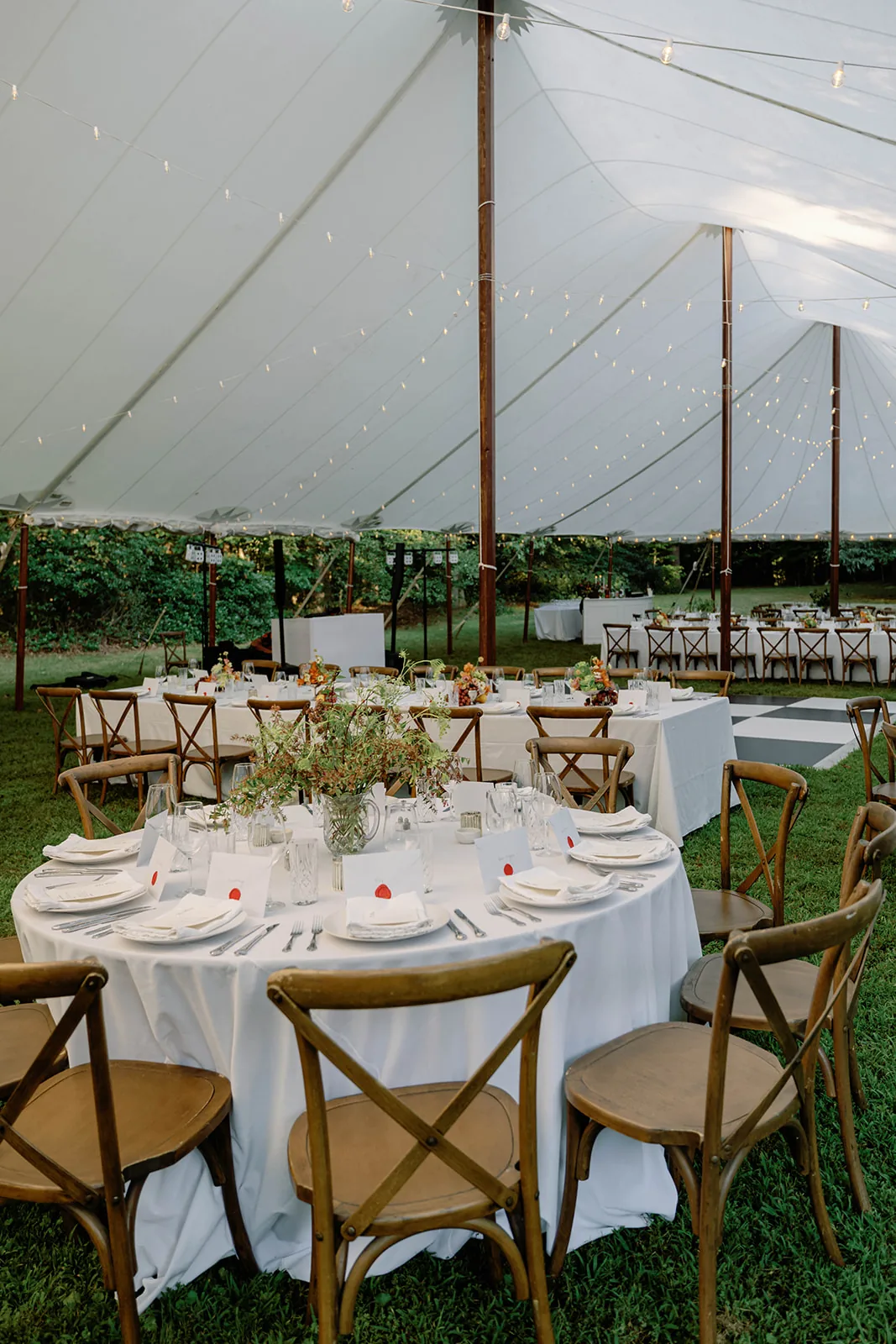 Round wedding table set inside a sailcloth tent