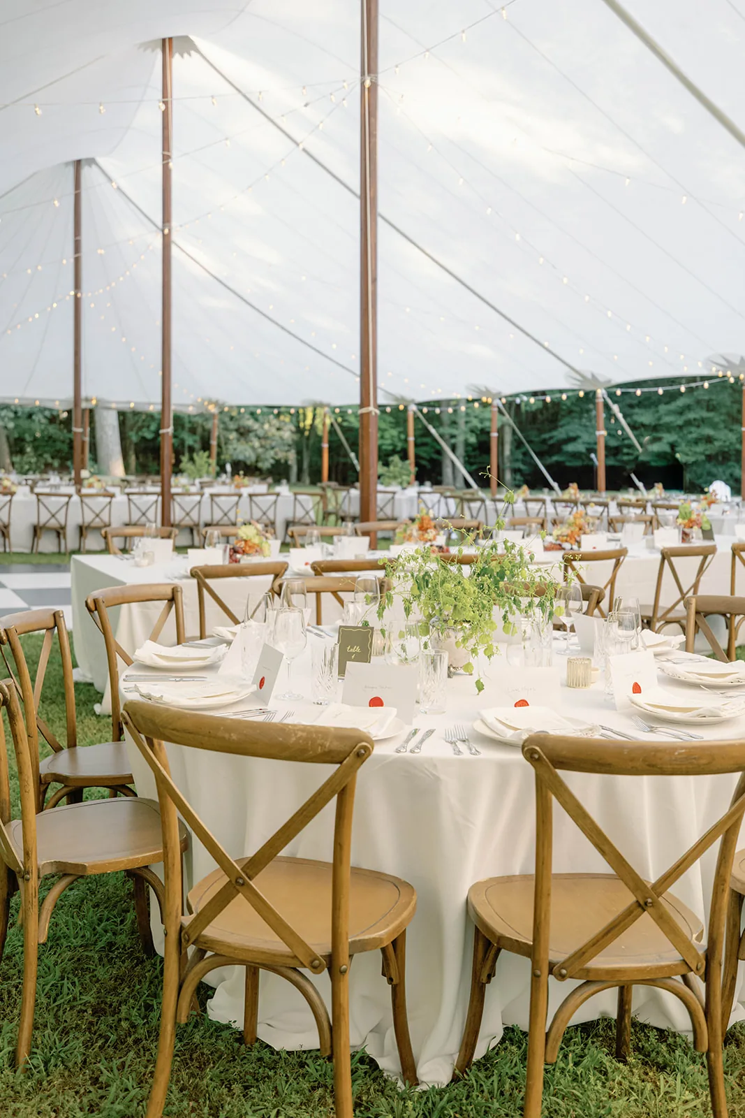 Floral centerpiece on a wedding table inside a sailcloth tent