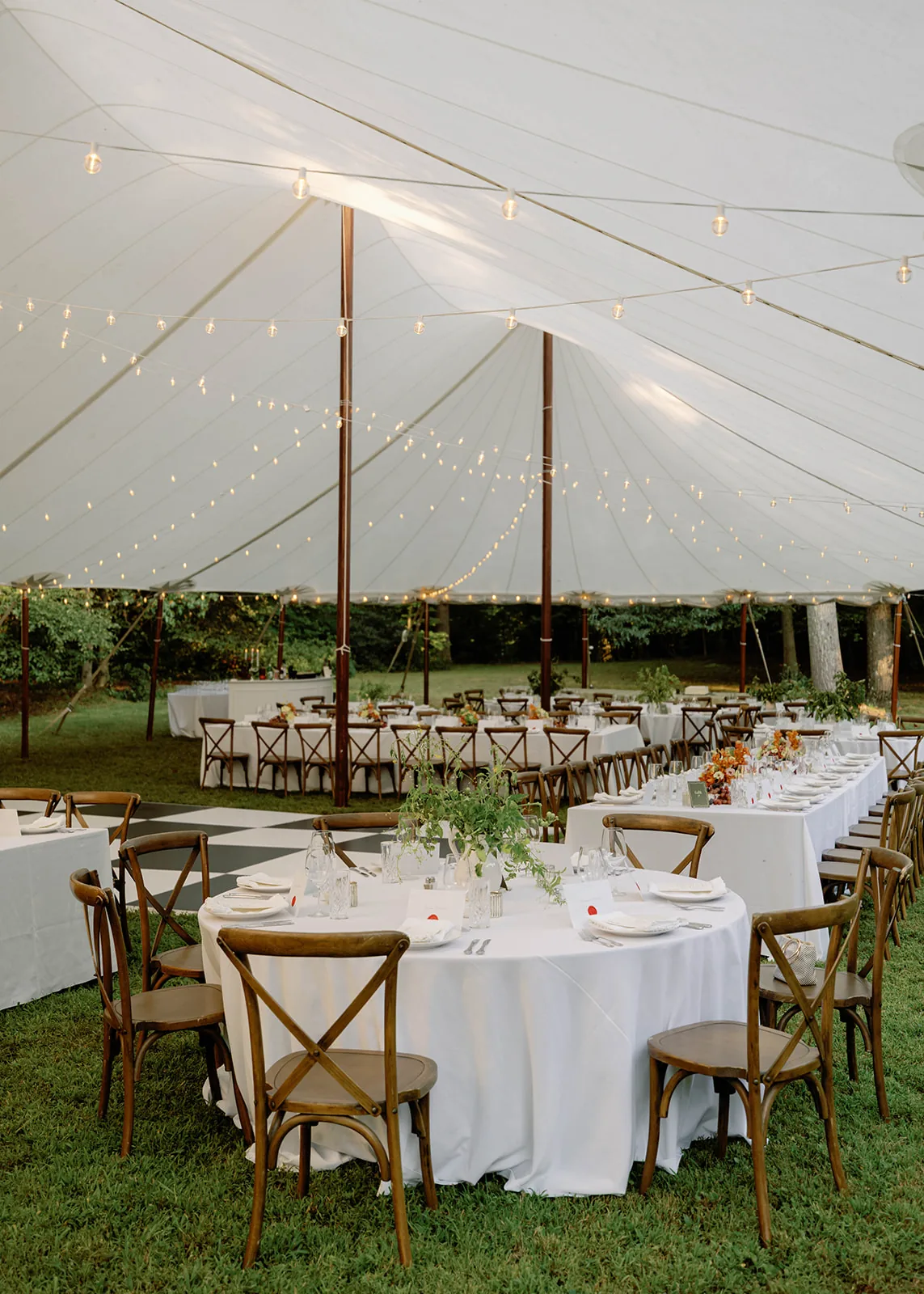 Reception setup inside a sailcloth wedding tent