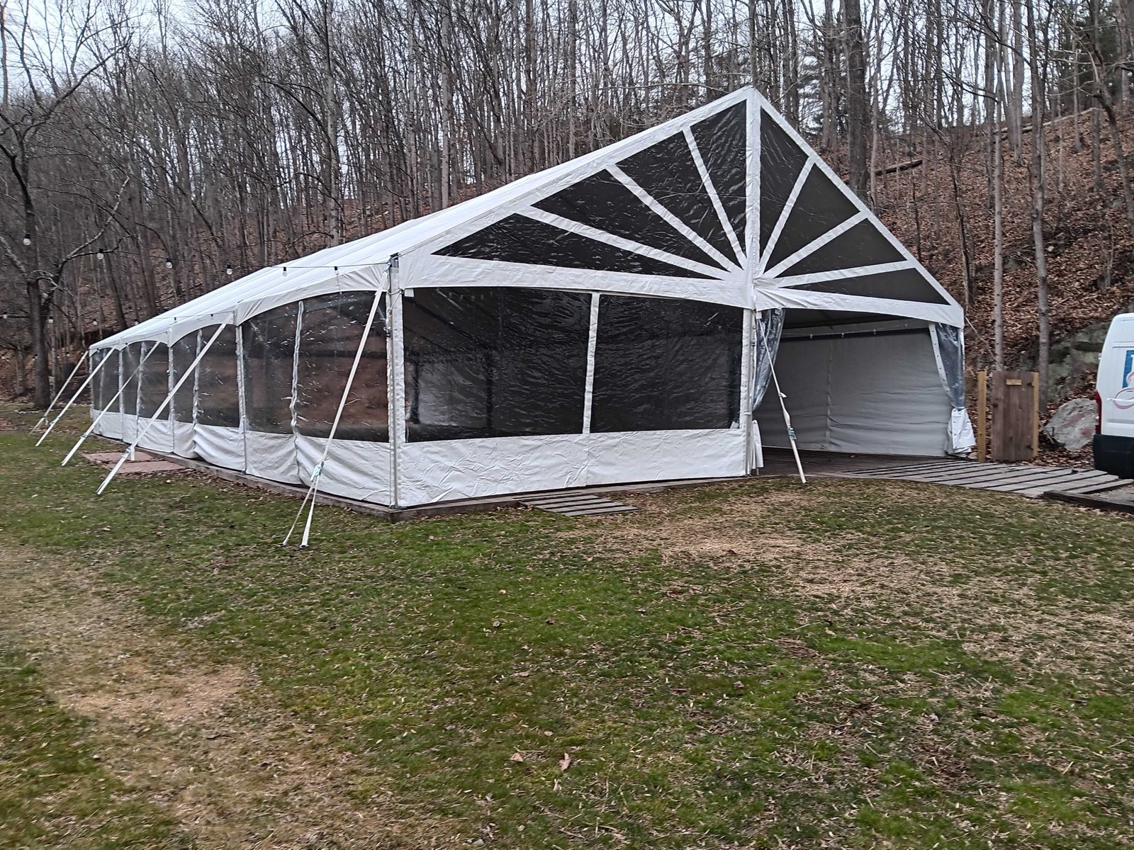 Structure tent in a wooded clearing