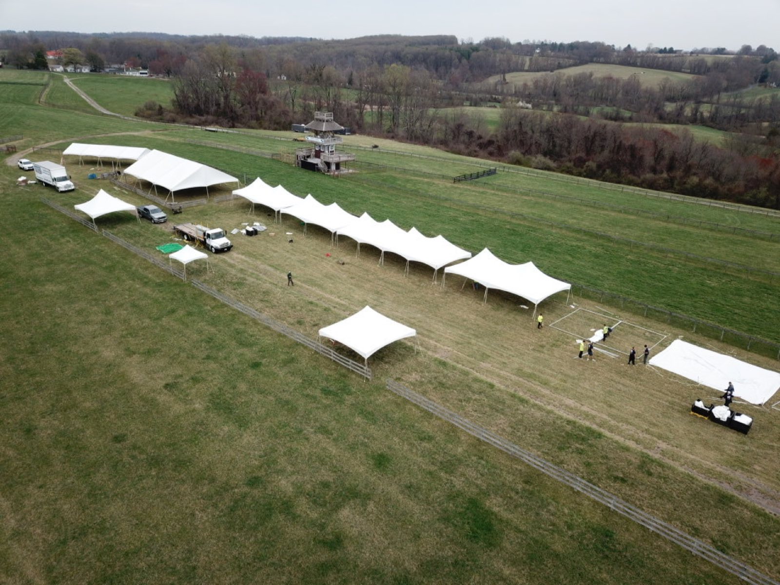 Aerial view of a multi-tent installation in progress