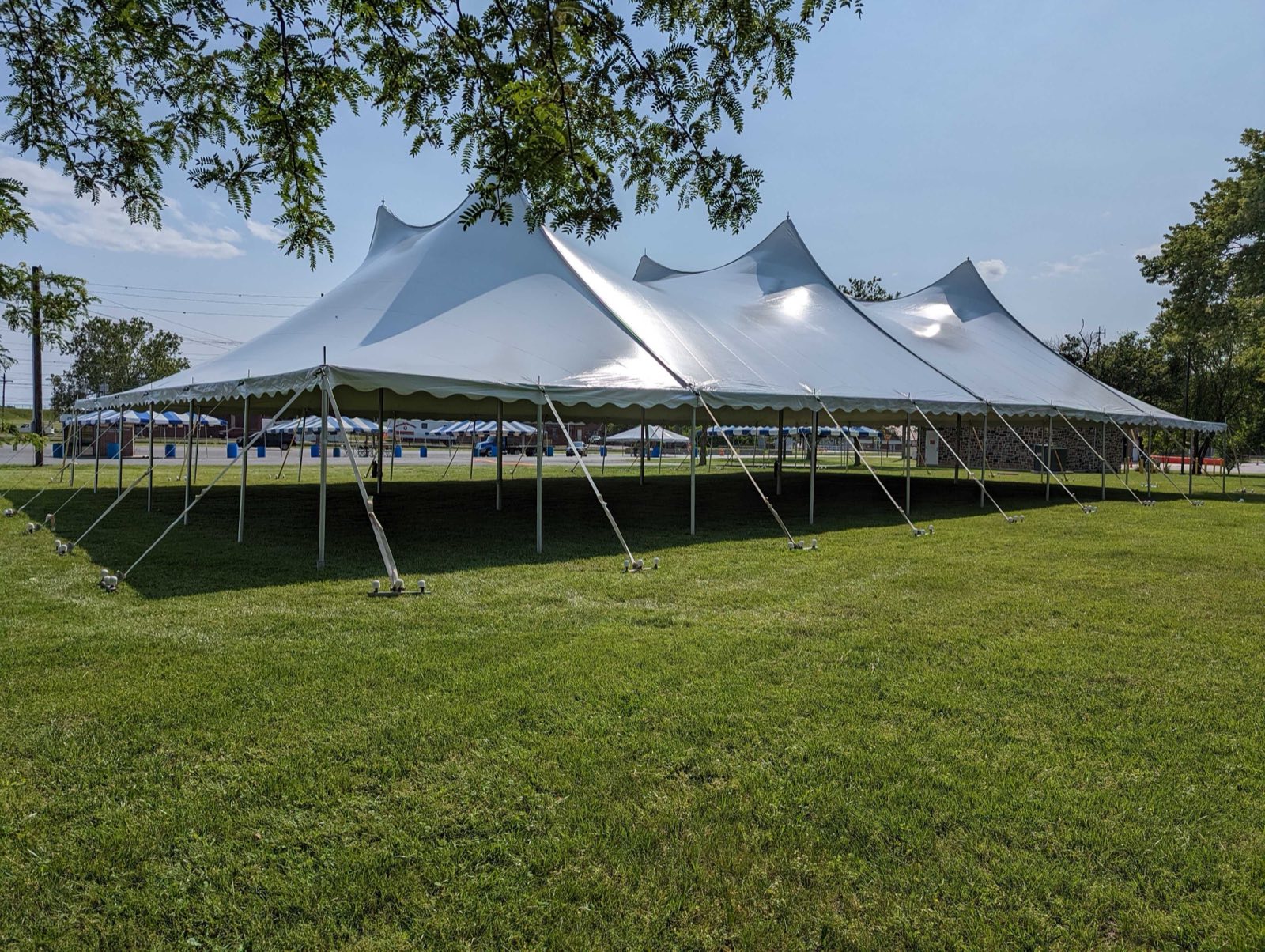 Twin-pole sailcloth tent in an open field