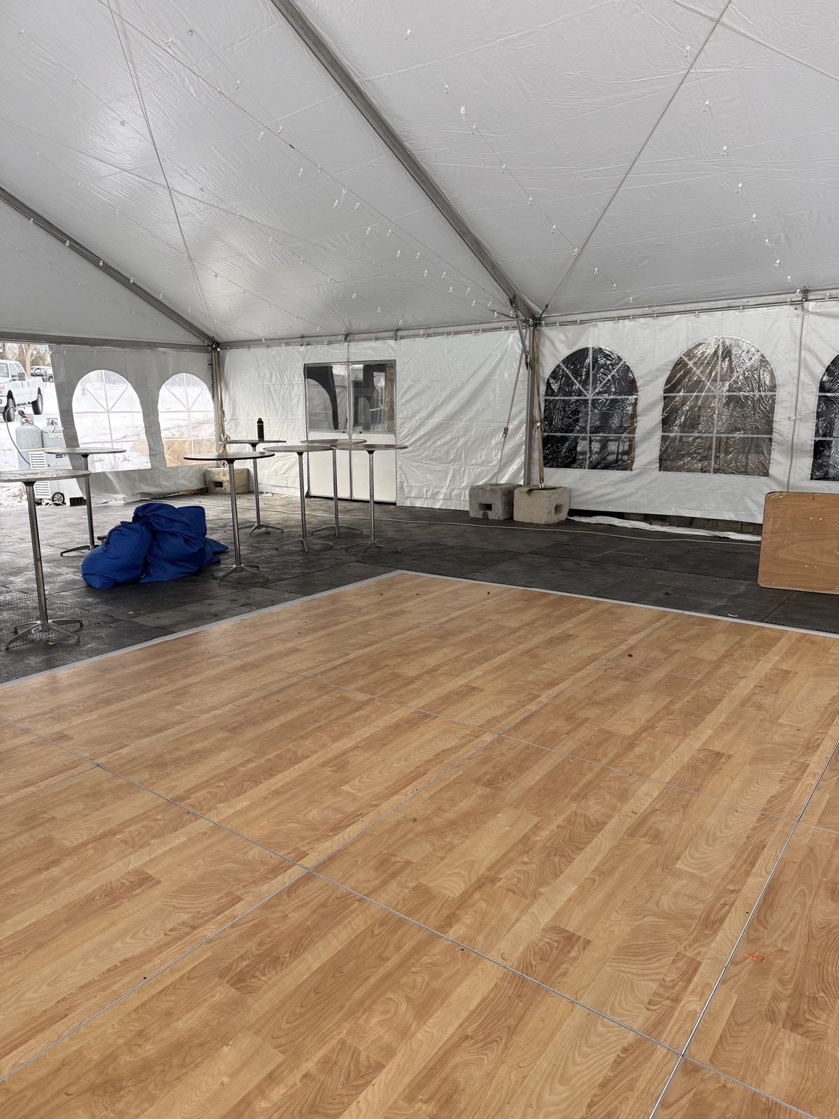 Wood-look dance floor inside a frame tent